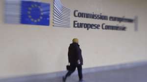 epa08795886 A picture taken with Lensbaby shows a person walking in front of European Commission headquarters in Brussels, Belgium, 03 November 2020.  EPA/OLIVIER HOSLET Taken with Lensbaby