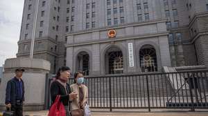 epa09230618 People walk past the Intermediate People's Court where Australian writer Yang Hengjun is expected to face trial, in Beijing, China, 27 May 2021. Australian writer Yang Hengjun, who was arrested in early 2019, is expected to face court in Beijing on espionage charges on 27 May 2021.  EPA/ROMAN PILIPEY