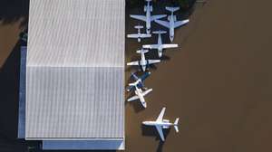 epaselect epa11323109 Aerial view showing planes on a flooded runway at Salgado Filho International Airport in Porto Alegre, Brazil, on 06 May 2024. Floods caused by heavy rains in southern Brazil have caused at least 86 deaths and 134 missing, according to the latest figures released 06 May by regional authorities.  EPA/Isaac Fontana