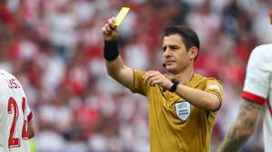 epa11428612 Referee Umut Meler shows a yellow card during the UEFA EURO 2024 group D soccer match between Poland and Austria, in Berlin, Germany, 21 June 2024.  EPA/HANNIBAL HANSCHKE