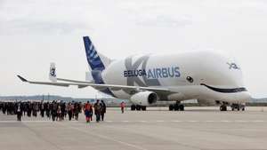 epa09136831 Several guests walk past an Airbus Beluga XL (Airbus A330-700L) aircraft during the opening of Airbus Defense and Space Campus, in the town of Getafe, outside Madrid, Spain, 15 April 2021.  EPA/Chema Moya