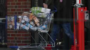 epa08294032 A man leaves a supermarket with a shopping cart full of goods in Berlin, Germany, 14 March 2020.  EPA/HAYOUNG JEON