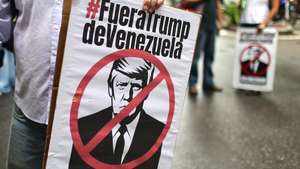 epa13246460 People hold signs bearing a crossed-out image of U.S. President Donald Trump during a march against the oil agreement between Venezuela and the United States in Caracas, Venezuela, 17 September 2026.  EPA/MIGUEL GUTIERREZ