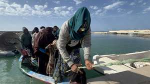 epa11040591 Migrants, who were rescued at sea by the Libyan Coast Guard after their boat sank in the Mediterranean, arrive on a boat in the port of Garaboli, east of Tripoli, Libya, 25 April 2023. The Libyan Red Crescent announced the recovery of 11 bodies of migrants from the shores of the town of Sabratha, west of Tripoli, bringing the number of bodies recovered in the past days to 34. Dozens of bodies have been washed ashore after two migrant boats sank in the Mediterranean off western Libya.  EPA/STRINGER