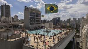 epa12613386 An aerial photograph shows people visiting the rooftop pool of the Sao Paulo State Trade Social Service building in Sao Paulo, Brazil, 26 December 2025. The Brazilian National Institute of Meteorology (Inmet) issued a red alert on 26 December for the entire territory of the states of Sao Paulo and Rio de Janeiro due to a heatwave that is expected to last until 29 December.  EPA/ISAAC FONTANA
