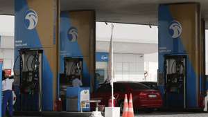 epa06855883 Fuel station workers pump petrol into a customer's car in the premium lane at a petrol station, Abu Dhabi, United Arab Emirates, 01 July 2018. Adnoc petrol stations had started on 30 June 2018 to collect from motorists 10 AED (2.75 USD) to fill and attendant pump their gasoline by their workers in specific lanes called 'premium serviceâ€™ and offering second option in another lane to other motorists to get fuel by themselves in lane called 'self-service'.  EPA/ALI HAIDER