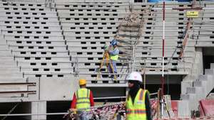 epa08083068 Construction workers at Lusail  Stadium during a media tour in Doha, Qatar, 20 December 2019. Lusail Stadium is one of the eight stadiums build for the FIFA World Cup 2022 in Qatar.  EPA/ALI HAIDER