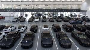 epa11927376 Tesla cars are parked at a delivery center in Beijing, China, 27 February 2025. Tesla began delivering the revised Model Y in China on 26 February. All of the cars parked in the indoor parking lot have already been sold to customers.  EPA/JESSICA LEE