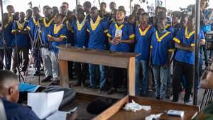 epa11602143 Some of the 51 defendants on trial for &#039;coup attemptâ€™ stand in the military court to hear their verdict in Nâ€™dolo military prison in Kinshasa, Democratic Republic of Congo, 13 September 2024. The military court is due to rule on the &#039;coup attempt&#039; that the Democratic Republic of Congo army says it foiled in May 2024. Some 51 individuals, including three Americans, are on trial for attempting to overthrow the president of the Democratic Republic of Congo on 19 May 2024. Six people were killed during the attempted coup including the suspected leader of the plot, Christian Malanga. They are charged with &#039;attack, terrorism, illegal possession of weapons and war munitions, attempted assassination, criminal association, murder and financing of terrorism&#039;, according to the military court president.  EPA/CHRIS MILOSI