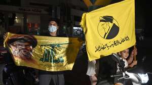 epa12355447 Supporters hold Hezbollah flags as they rally to protest against the Lebanese government's endorsement of a plan to disarm the militant group, in a southern suburb of Beirut, Lebanon, 05 September 2025. The Lebanese government endorsed the army's plan to disarm Hezbollah in a cabinet meeting on 05 September.  EPA/WAEL HAMZEH