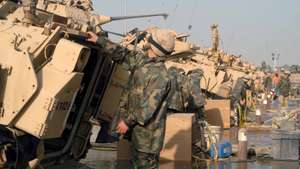 epa01820979 (FILE) A file photo dated 23 February 2004 showing US army soldiers wash their military vehicles at Camp Arifjan, Kuwait. Kuwaiti officials informed on 11 August 2009 that Kuwaiti authorities have arrested an al-Quaeda-linked group planning to attack a US military base in the small oil-rich state. The Interior Ministry said in a statement on 11 August 2009 that a 'terrorist cell' of six Kuwaitis were in custody and have confessed to a plot to attack Camp Arifjan as well as the headquarters of the country's internal security agency.  EPA/RAED QUTENA