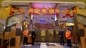 epa08228734 Casino workers wearing protective masks await customers as the Casino reopens in Macao, China, 20 February 2020. Twenty-nine casinos are to reopen starting 20 February, and 12 remain closed, the authorities of the gambling capital said, one of the regions that have identified cases of infection by the coronavirus Covid-19.  After 15 days of closure, Macau's government said on 17 February that the casinos could reopen, giving operators 30 days to return to business.  EPA/CARMO CORREIA