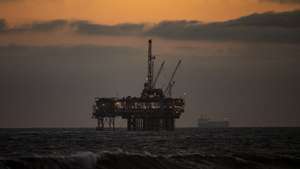 epa08416024 An oil rig sits off the shore at sunset in Huntington Beach, California, 11 May 2020. California begane it's Phase 2 of reopening, after coronavirus restrictions, on 08 May 2020.  EPA/ETIENNE LAURENT