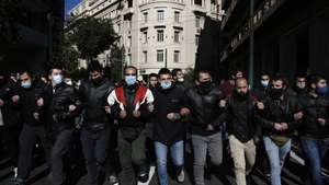 epa08955360 University students shout slogans as they take part in a protest against the education ministry's new bill in front of Greek Parliament, Athens, Greece, 21 January 2021. Students and professors protested against proposals for a university police force, changes in the system for admission to higher education and a number of other issues.  EPA/YANNIS KOLESIDIS
