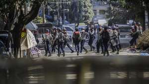 epa09061026 Police officers search for hiding demonstrators during a protest in Yangon, Myanmar, 08 March 2021. Major trade unions in Myanmar called on members to go on strike on 08 March to shut down the economy amid intensifying violent crackdowns on demonstrators by security forces. More than 50 people have died in the crackdown by security forces, since the military coup on 01 February 2021.  EPA/LYNN BO BO