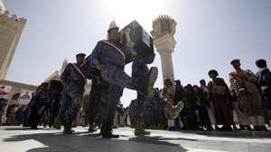 epa09091201 Pro-Houthi soldiers carry the coffins of slain Houthi fighters during a funeral procession a day after a Yemen peace initiative was offered by Saudi Arabia, in Sana'a, Yemen, 23 March 2021. Saudi Arabia has offered a peace initiative to the Houthis in Yemen, including a ceasefire and the reopening of Sana’a airport. A Saudi-led coalition has been fighting the Houthis since March 2015.  EPA/YAHYA ARHAB