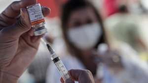 epa09105059 A health professional prepares a vaccine against Covid-19, in the city of Duque de Caxias, Brazil, 29 March 2021. The mayor of the city reported that anyone older than 65 years will be able to get vaccinated, which caused thousands of people to wait in long lines to receive the Coronavac vaccine against COVID-19.  EPA/Antonio Lacerda
