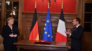 epa09562175 France's President Emmanuel Macron (R) applauds outgoing German Chancellor Angela Merkel (L), during the ceremony of the Grand Cross, the highest distinction of the Legion d'Honneur, France's chief honour, in Beaune, Eastern France, on 03 November 2021. Macron hosted outgoing Chancellor Angela Merkel for a valedictory visit as she bows out after 16 years in power, with the German leader cheered by crowds and awarded France's highest honour.  EPA/PHILIPPE DESMAZES / POOL  MAXPPP OUT