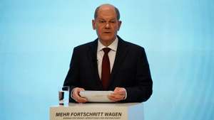 epa09600820 Acting German Minister of Finance and Social Democratic Party (SPD) top candidate for the federal elections Olaf Scholz speaks during the presentation of the coalition contract in Berlin, Germany, 24 November 2021. Members of German parties Social Democrats (SPD), Free Democrats (FDP ) and Greens were leading talks since German federal elections took place on 26 September 2021. Olaf Scholz will head a three-party coalition with broad plans for Germany&#039;s transition to a green economy, under a deal to end 16 years of government led by Angela Merkel.  EPA/CLEMENS BILAN