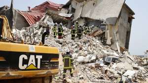 epa09807780 Rescuers work amid the rubble of a collapsed building in the Cocody district of Abidjan, Ivory Coast, 07 March 2022. According to the firefighters, at least four people died and 30 rescued including 13 taken to hospital, after a five-story apartment collapsed overnight in Abidjan.  EPA/LEGNAN KOULA
