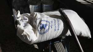 epa08963061 Free food rations provided by the World Food Programme (WFP) are unloaded for a Yemeni at an aid distribution center in Sana'a, Yemen, 24 January 2021. According to reports, 22 aid agencies working in Yemen have called for the US administration of President Biden to revoke the designation of the Houthis movement as a foreign terrorist organization, warning that any disruption to lifesaving aid operations and essential commercial imports will put millions of lives at risk and could chill peace efforts.  EPA/YAHYA ARHAB