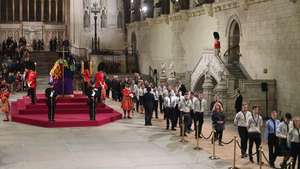 epa10192662 Guards are changed as mourners file past the coffin as they attend the Lying-in-State of Britain's Queen Elizabeth II at the Palace of Westminster in London, Britain, 18 September 2022. The queen's lying in state will last for four days, ending on the morning of the state funeral on 19 September.  EPA/NEIL HALL