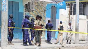 epa10130095 Somali security officials gather at the cordoned-off scene of an attack, outside the Hayat Hotel in Mogadishu, Somalia, 20 August 2022. According to Somaliaâ€™s security officials, at least 10 people were killed in the attack reportedly carried out by al-Shabab militants on 19 August. The attack involved explosions outside the hotel and gunfire.  EPA/SAID YUSUF WARSAME