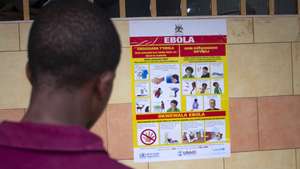 epa10212386 A man looks at an Ebola virus disease awareness campaign poster following an outbreak of Ebola in Uganda, in Kampala, Uganda, 28 September 2022. According to Uganda&#039;s Health Ministry, Ebola infections have risen across some districts in Uganda with the number of confirmed and suspected deaths at 36. The president addressed the nation on measures the government is putting in place to mitigate the spread.  EPA/Stringer