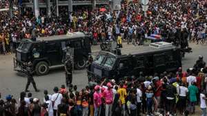 The police force intervenes during the procession in honor of the kuduro musician known as 'Nagrelha' on the outskirts of the Santa Ana cemetery in the city, near Luanda, Angola, 22 November 2022. Gelson Caio Manuel Mendes, better known as 'Nagrelha', the most famous singer in the kuduro musical style, died in Luanda, of lung cancer, according to the Complexo Hospitalar de Doenças Cardiovasculares Dom Alexandre do Nascimento, where he was being cared for. He was 36. AMPE ROGERIO/LUSA