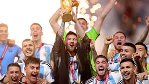 epa10373065 Lionel Messi (C) of Argentina lifts the World Cup trophy after winning the FIFA World Cup 2022 Final between Argentina and France at Lusail stadium, Lusail, Qatar, 18 December 2022.  EPA/Friedemann Vogel