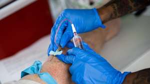 epa08829970 Brian has a sample of his blood taken for tests at a free coronavirus antibodies test site at the Calvary Baptist Church amid COVID-19 pandemic in Santa Monica, California, USA, 19 November 2020.  EPA/ETIENNE LAURENT
