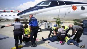 epa10647637 Police officers arrest environmental activists of Stay Grounded, Greenpeace, Extinction Rebellion and Scientist Rebeillion as they protest by being handcuffed to an aircraft during the European Business Aviation Convention and Exhibition (EBACE), at the Geneva Airport in Geneva, Switzerland, 23 May 2023. Europe's premier on-demand aircraft and advanced air mobility event is taking place in Geneva from 23 to 25 May.  EPA/LAURENT GILLIERON