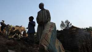 epa10135166 Sudanese people stand amid a flooded area of Al Jazirah state, Sudan, 23 August 2022. According to the Sudanese Council for Civil Defense, at least 79 people died in incidents related to the recent floods in the country. Thousands of homes were damaged due to the floods that affected South Darfur, North Kordofan, and Al Jazirah state.  EPA/MOHND AWAD