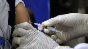 epa10824797 A school child receives an injection during a vaccination program of the Measles-Rubella (MR) and Human Papillomavirus (HPV) in Banda Aceh, Indonesia, 28 August 2023. The Human Papillomavirus (HPV) vaccination program is for school children at the fifth grade of Elementary school as a preventive action against cancer in the genital area and reproductive organs such as cervical cancer and penile cancer.  EPA/HOTLI SIMANJUNTAK