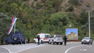 epa10880551 Kosovo police officers guard the road near the village of Banjska following an attack, in Kosovo, 24 September 2023. At least one policeman was killed and another was wounded - Kosovo Prime Minister Albin Kurti confirmed on 24 September - in an attack the premier blamed on armed personnel coming from Serbia. Kosovo police have surrounded the local XIV century Serbian Orthodox Banjska monastery, stating the armed assailants are hiding in the premises. The incident comes at a fragile moment in the Kosovo - Serbia European Union-facilitated dialogue to normalize ties between the two parties.  EPA/STR