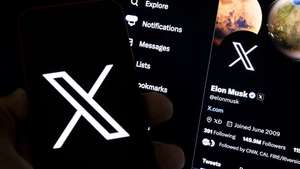 epa10772473 An illustration pictures shows a user holding a mobile phone displaying the 'X' logo in front of Elon Musk's page in Los Angeles, California, USA, 27 July 2023. Twitter announced on 23 July that it will rebrand to X.  EPA/ETIENNE LAURENT