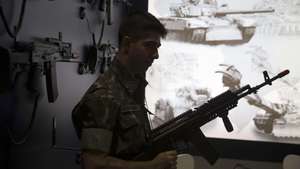 epa04704654 A Brazilian soldier holds a machine gun as he visits the International Fair LAAD Defense &amp; Security in Rio de Janeiro, Brazil, 14 April 2015. The event, the biggest of the Defense sector in Latin America, will run until 17 April.  EPA/Marcelo Sayao