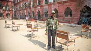 epa11062388 An election official stands at a polling center during the 12th national general election in Dhaka, Bangladesh, 07 January 2024. The last general election in Bangladesh was held in 2018. People are voting to select members of the national parliament, also known as Jatiya Sangsad.  EPA/MONIRUL ALAM