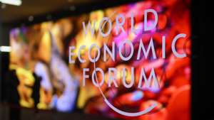 epa11077126 The logo of the WEF on a window of the Congress Center as participants and artificial intelligence generated artwork by Turkish-American media artist Refik Anadol are reflected inside the congress centre on the eve of the 54th annual meeting of the World Economic Forum (WEF) in Davos, Switzerland, 14 January 2024. The meeting brings together entrepreneurs, scientists, corporate and political leaders in Davos under the topic 'Rebuilding Trust' from 15 to 19 January.  EPA/LAURENT GILLIERON