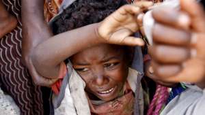 epa01507772 A young boy cries while waiting in line at an outreach clinic run by Medecins Sans Frontiers (MSF) (Doctors Without Borders) in the village of Faajjii Gollee, 250kms south of Addis Ababa, 01 October 2008. A lack of rain in the main February to April wet season has left at least 75,000 Ethiopian children under age five at risk from malnutrition, according to the UN's Office for the Coordination of Humanitarian Affairs (OCHA) who also asserts that some eight million people need urgent food relief and another 4.6 million need emergency assistance. 

Almost 40,000 people have received either therapeutic or enriched food through MSF nutrition activities in the South of Ethiopia over the last four months but according to staff crowds still throng at the entrance of the nutrition centres to try to get something to eat.  EPA/STEPHEN  MORRISON