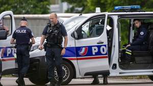 epa11339833 French policemen stand guard at the toll station of Incarville, near Rouen, in the North of France, where gunmen ambushed a prison van on 14 May 2024, killing two prison guards and helping a prisoner to escape. Three other prison guards were severely wounded, according to Justice minister Eric Dupond-Moretti. A major police manhunt has been launched to find the gunmen and the escaped prisoner,  identified as a 30-year-old drug dealer from northern France, according to the Paris prosecutor's office.  EPA/CHRISTOPHE PETIT TESSON