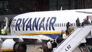 epa11310199 Passengers board a Ryanair group airplane at Riga Airport, Latvia, 30 April 2024. Riga Airport is the international airport of Riga, the capital of Latvia, and the largest airport in the Baltic states.  EPA/TOMS KALNINS