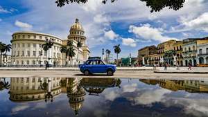 epa11423696 A car drives near the Capitol in Havana, Cuba, 19 June 2024.  EPA/YANDER ZAMORA