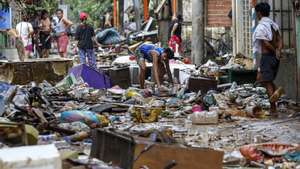 epa11495309 A resident looks for reusable material from trash and debris along a street a day after massive flooding in Marikina City, Metro Manila, Philippines, 25 July 2024. A state of calamity was declared in the Philippine capital of Metro Manila and neighboring provinces in order to activate resources to address effects of massive floods from monsoon rainfall caused by typhoon Gaemi on 24 July. Flood evacuees began returning to their homes while other affected families still remain in evacuation centers in need of relief supplies.  EPA/ROLEX DELA PENA