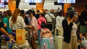 epa11495349 Travellers queue for departure check-in after multiple international flights have been cancelled or delayed, at Taoyuan International Airport, in Taoyuan, Taiwan, 25 July 2024. As of 16:30 on 25 July local time has typhoon Garmin taken at least three lives, injured more than 200 people and damaged structures all over Taiwan, according to the Central Emergency Operations Center. With domestic and international flights cancelled and trains services suspended it is the strongest tropical storm in eight years.  EPA/DANIEL CENG