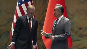 epa11566639 Wang Yi (R), Foreign Minister of China, gestures near White House national security adviser Jake Sullivan before their talks at Yanqi lake in Beijing, China, 27 August 2024. Sullivan meets with Chinese Foreign Minister Wang Yi with the aim of improving US-China relations.  EPA/Ng Han Guan / POOL