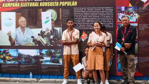 People pose next to a panel of the 25th anniversary of the referendum during the visit of the Secretary-General of the United Nations (UN) Antonio Guterres (not seen) to the permanent exhibition of the Timorese Resistance Archive &amp; Museum and the exhibition on Women of the Resistance 1975 – 1999 &#039;Matria&#039;, as part of the commemorations of the 25th anniversary of the referendum for the self-determination of East Timor, in Dili, East Timor, 29 August 2024. PAULO NOVAIS/LUSA