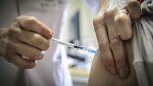 A woman is vaccinated in the first day of vaccine administration in health centers for people over 80 years old and over 50 years old and associated pathologies, integrated in the first phase of the Vaccination Plan against covid-19, in the Family Health Units (USF) at the Alvalade Health Center - Family Health Unit in Lisbon, Portugal, 03 February 2021. ANDRE KOSTERS/POOL/LUSA