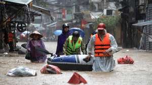 epa11598423 People push an inflatable boat through the flood waters in a street of Hanoi, Vietnam, 11 September 2024. Typhoon Yagi, which struck northern Vietnam over the weekend, triggered severe flooding in Hanoi. The Red River&#039;s rapid rise inundated communities along the riverbank, forcing residents to seek refuge in safer areas. As of 11 September, the Vietnam Disaster and Dyke Management Authority reported at least 152 fatalities and 140 missing persons due to the typhoon.  EPA/LUONG THAI LINH