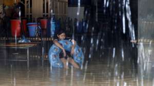 epa11597963 A girl sits inside her flooded home in Hanoi, Vietnam, 11 September 2024. Typhoon Yagi, which struck northern Vietnam over the weekend, triggered severe flooding in Hanoi. The Red River&#039;s rapid rise inundated communities along the riverbank, forcing residents to seek refuge in safer areas. As of 11 September, the Vietnam Disaster and Dyke Management Authority reported at least 152 fatalities and 140 missing persons due to the typhoon.  EPA/LUONG THAI LINH